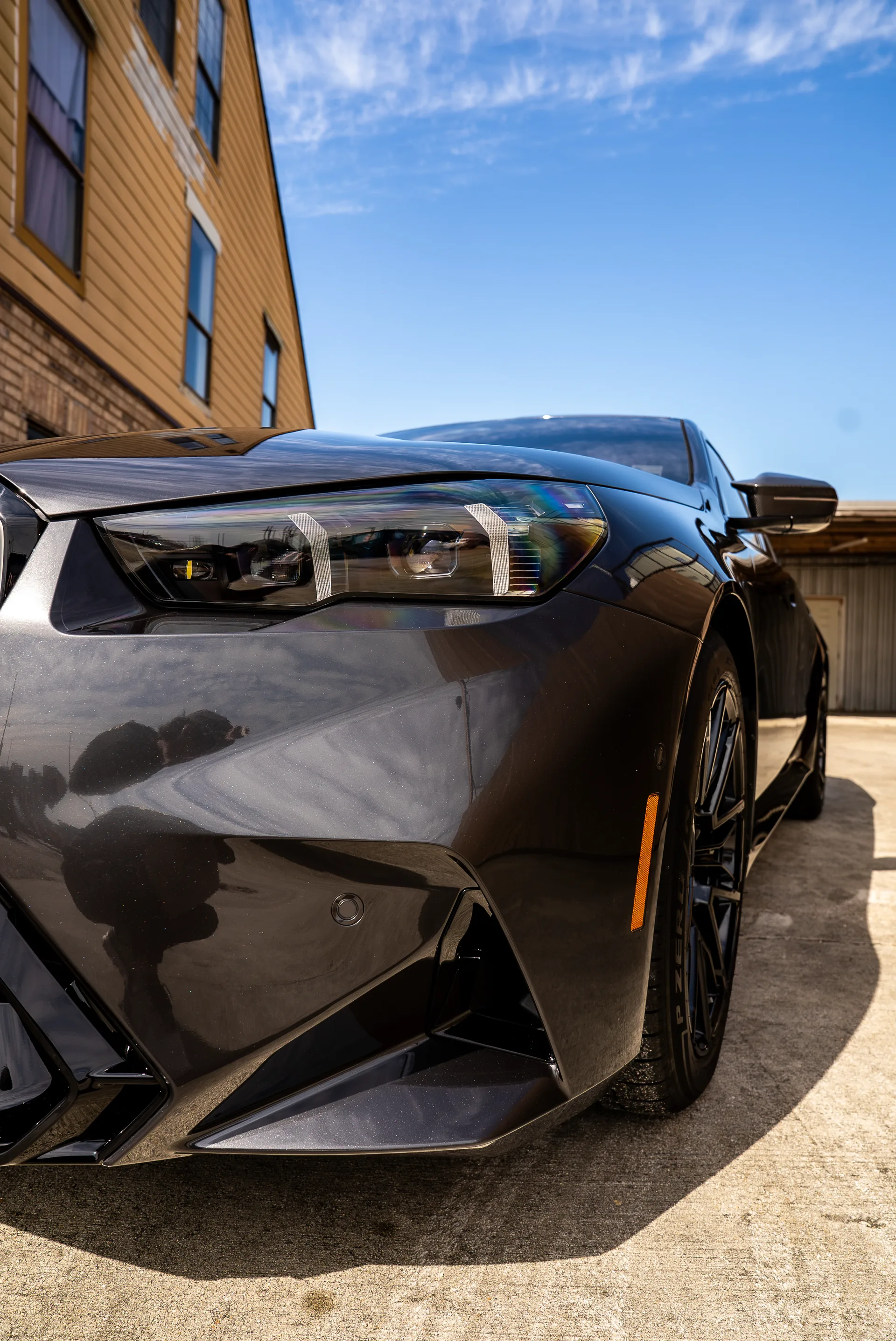 Photographer capturing detail shots of a BMW M5's protected front end
