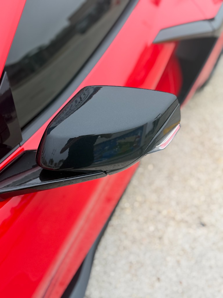 Dark window tint on a red vehicle at Surface Protection Studio